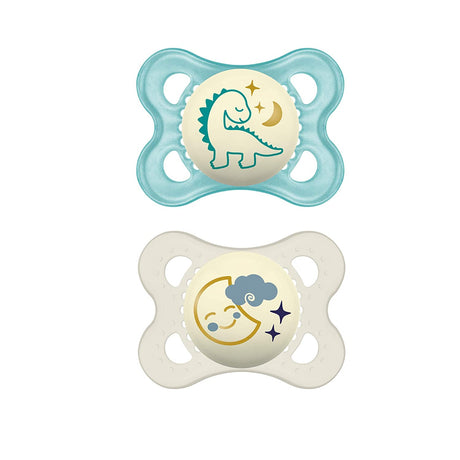 Paire de sucettes silicone vert eau et blanc cassé, motifs dinosaure et lune.